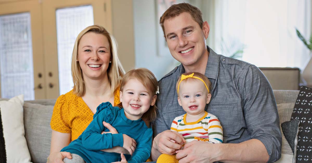 Dr. Karri Adamson, a plastic surgeon with Plastic Surgery & Skin Specialists by BayCare Clinic, poses with her husband and two young daughters.