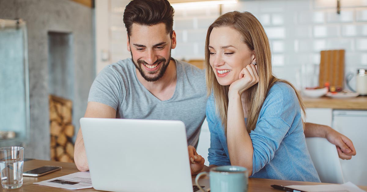 A young couple reviewing medical chart on computer