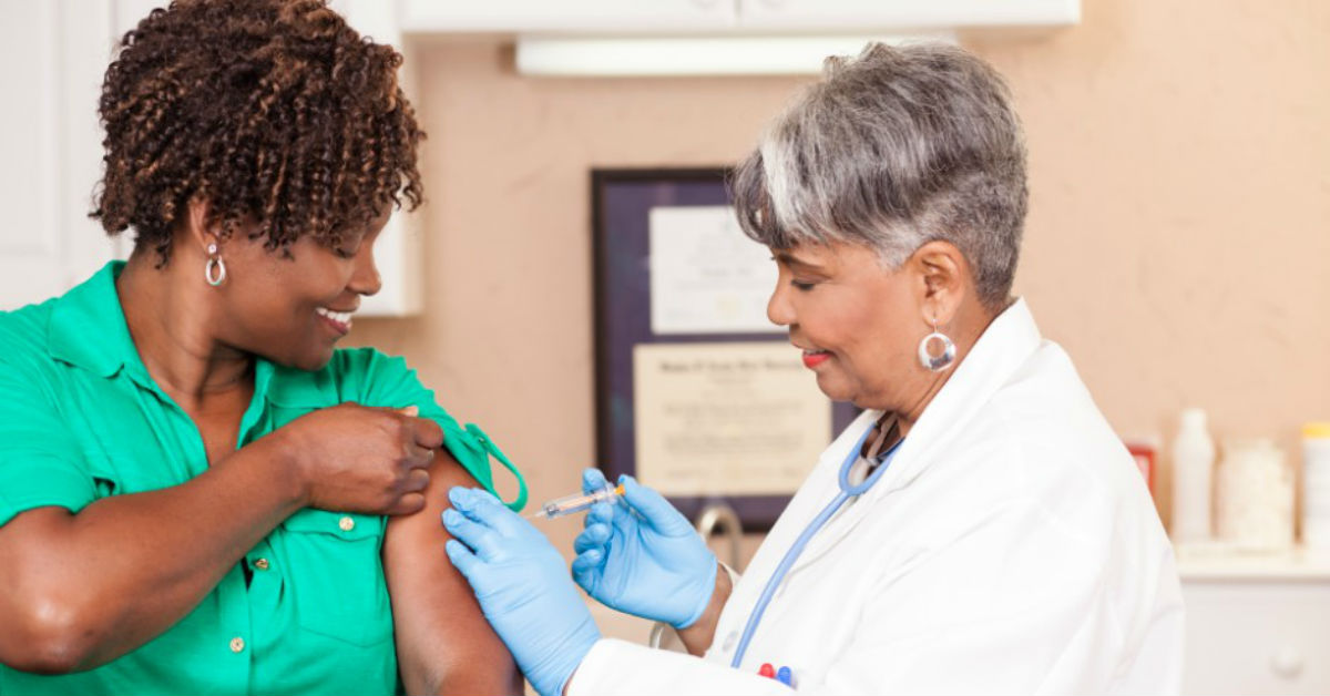 Patient receiving flu shot from doctor