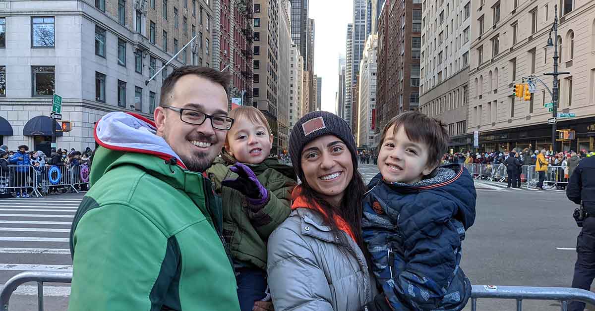 Family poses for photo on a city street