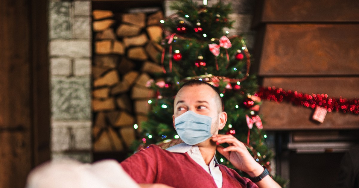 Man at holiday gathering wearing a protective mask